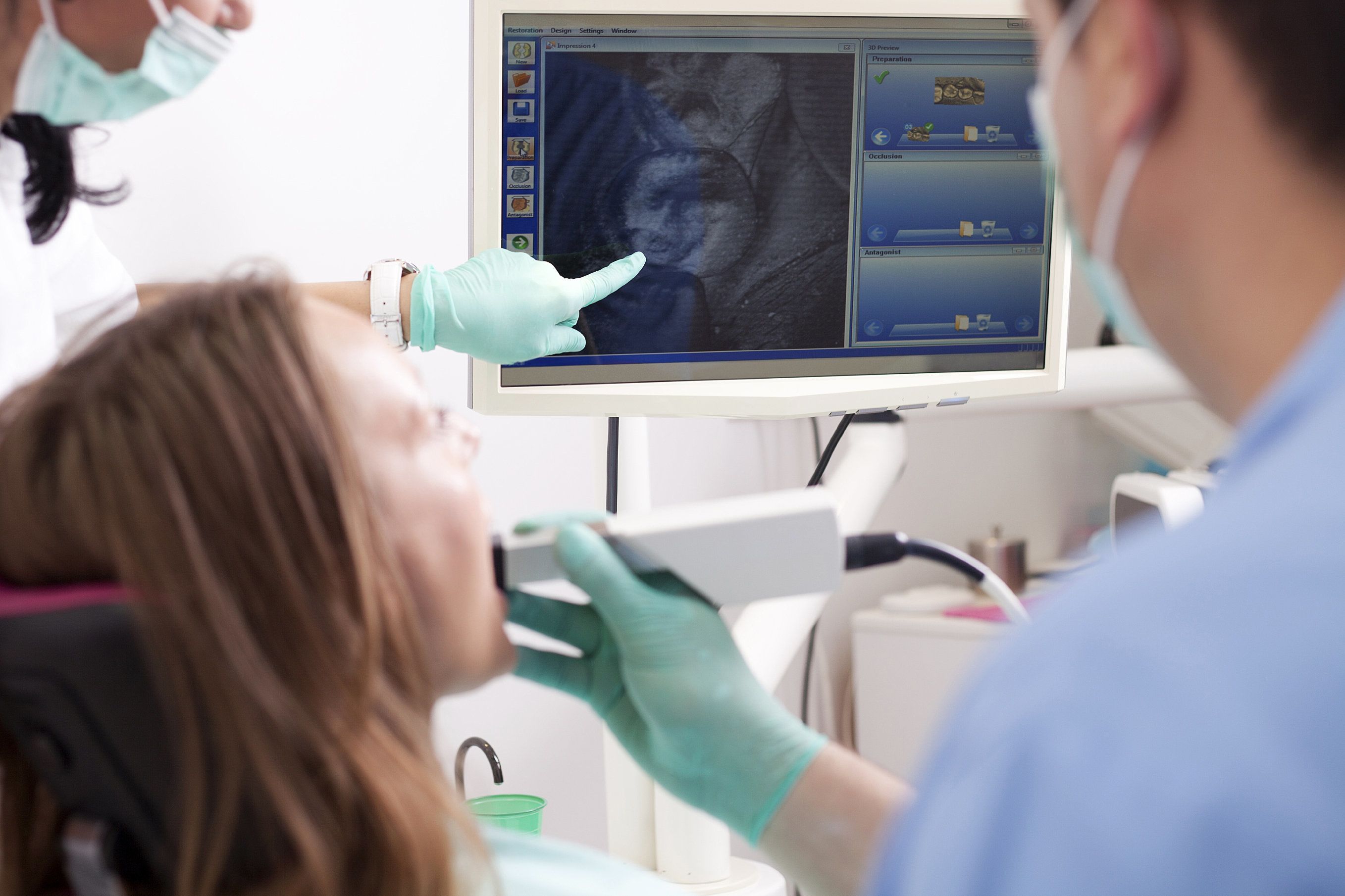 Doctor showing patient intraoral camera picture